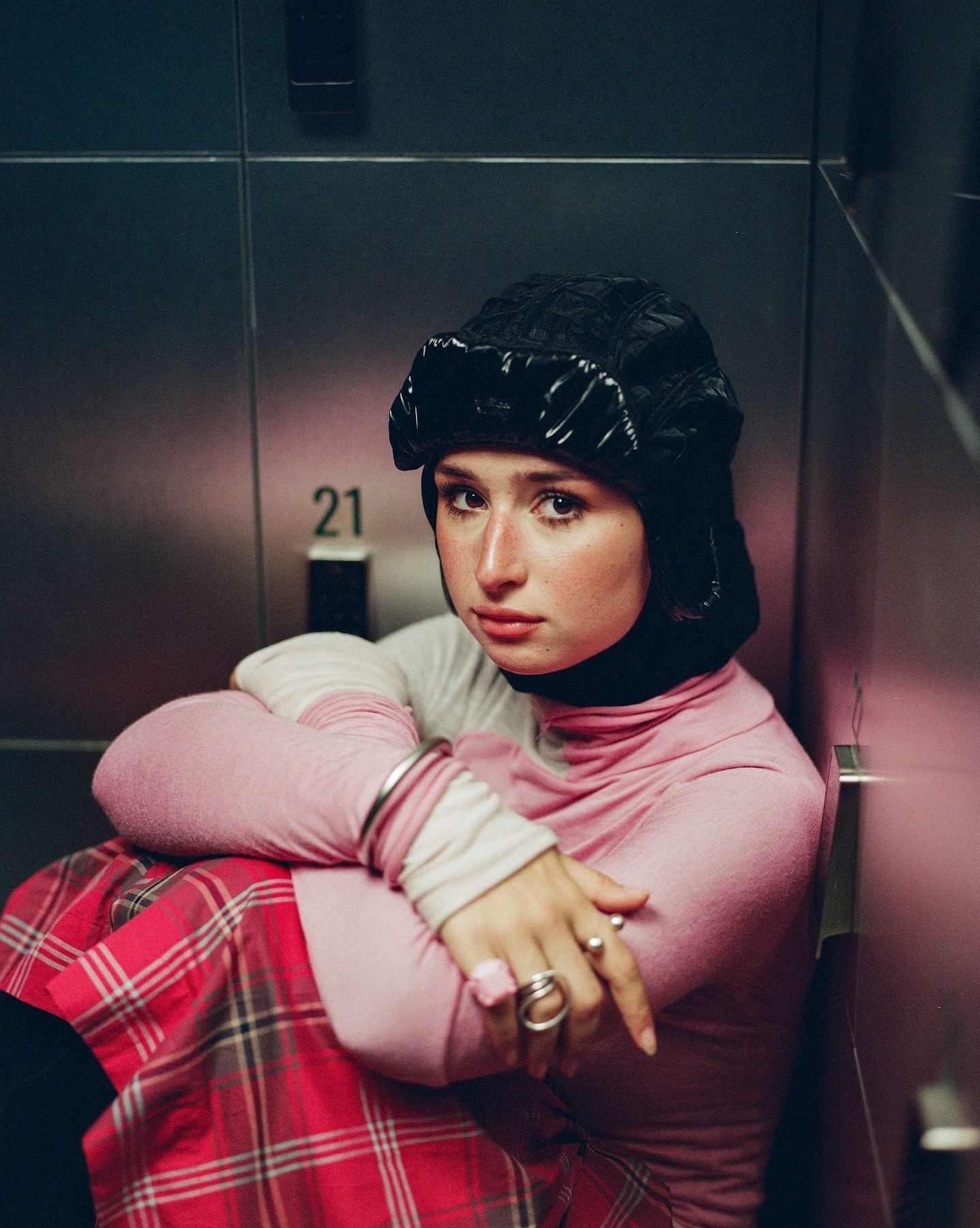 AXIS: woman crouched in a lift